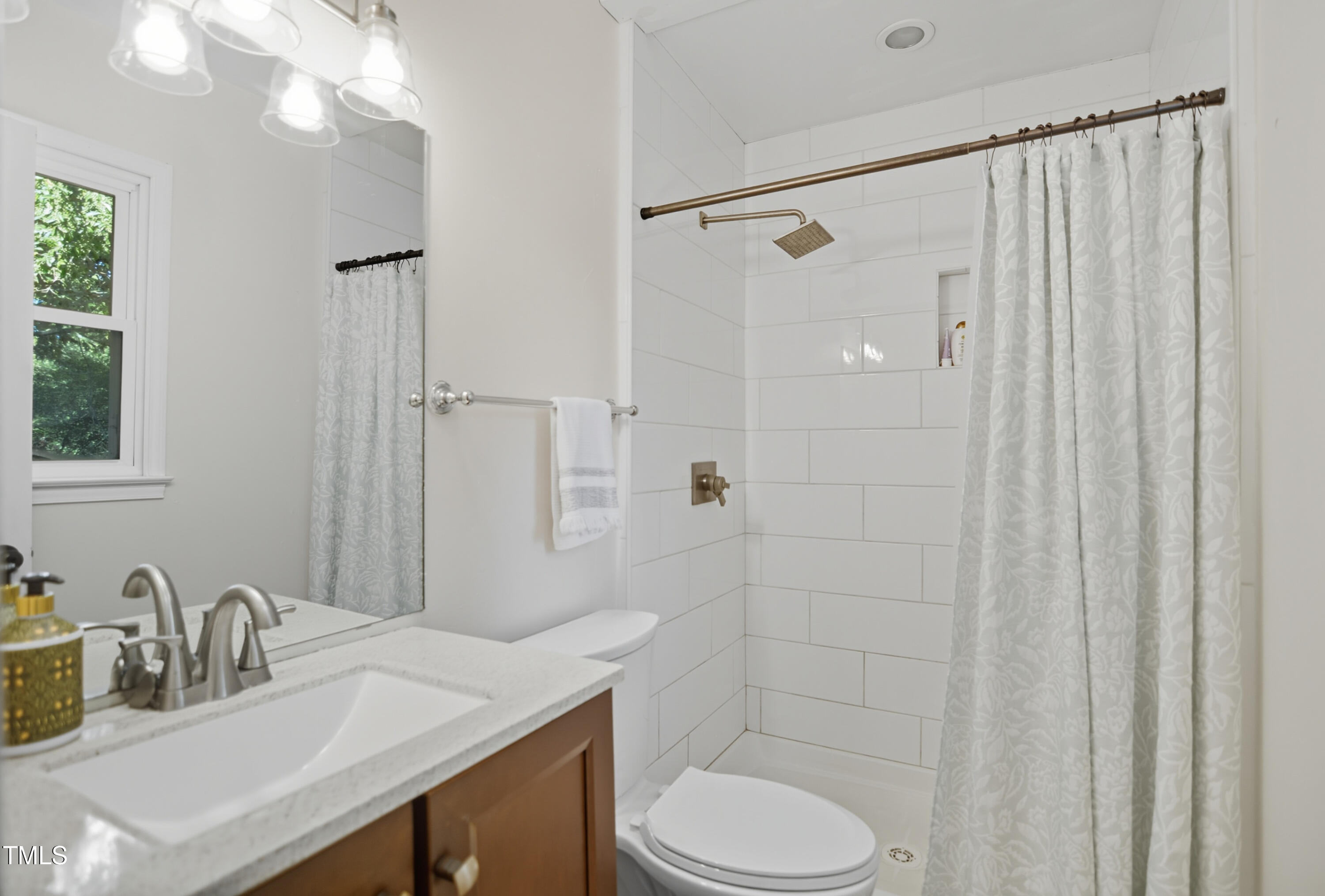 1421 Lions Way Raleigh, NC 27604 - Photo 11 of 22 a bathroom with a sink toilet and shower