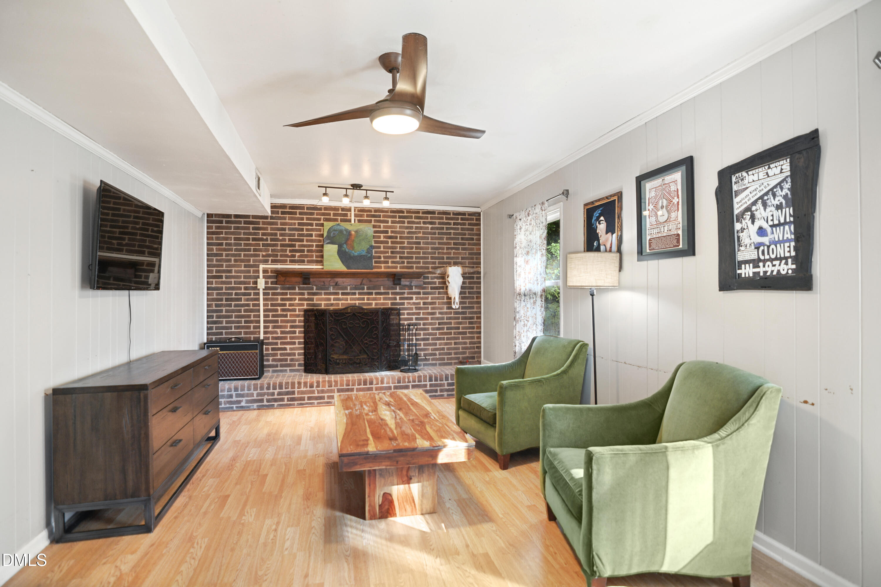1421 Lions Way Raleigh, NC 27604 - Photo 13 of 22 a living room with furniture a flat screen tv and a fireplace