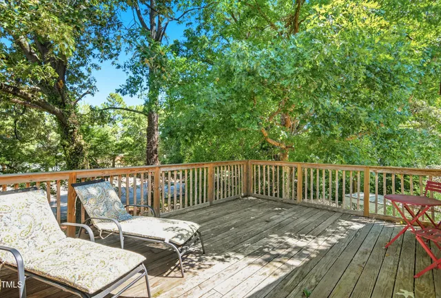 a view of balcony with wooden floor and outdoor seating