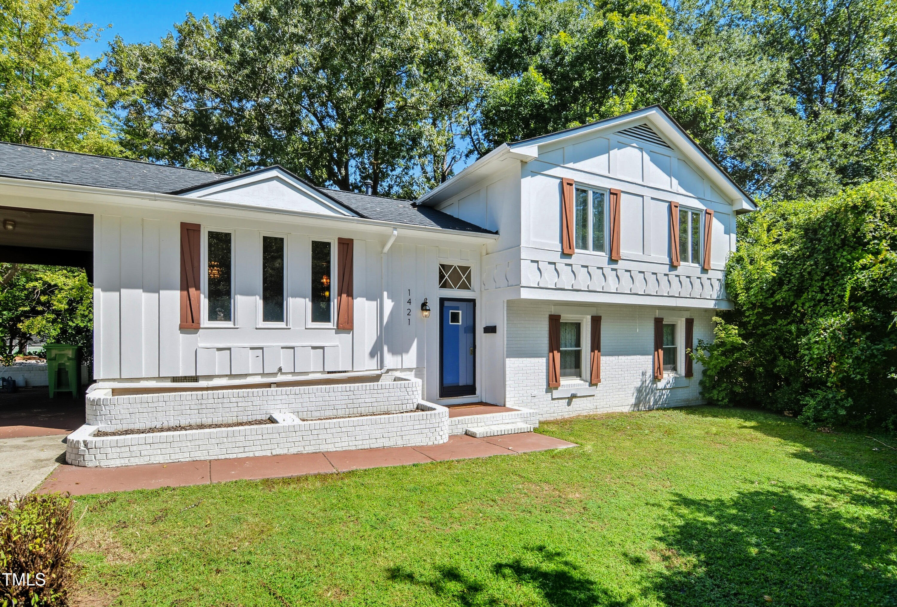 1421 Lions Way Raleigh, NC 27604 - Photo 2 of 22 a front view of a house with a yard table and chairs