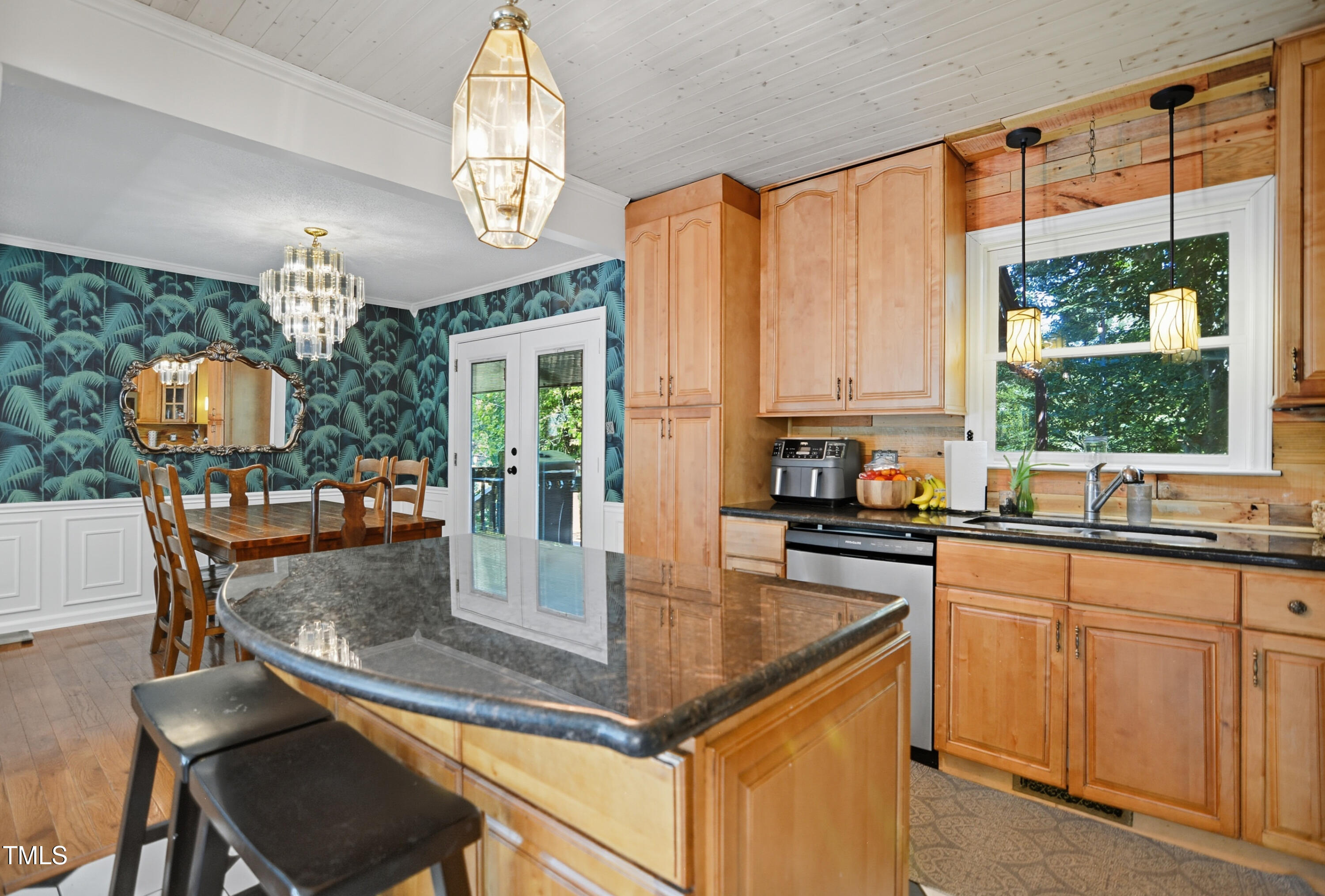 1421 Lions Way Raleigh, NC 27604 - Photo 9 of 22 a kitchen with granite countertop a stove a sink dishwasher a dining table and chairs with wooden floor