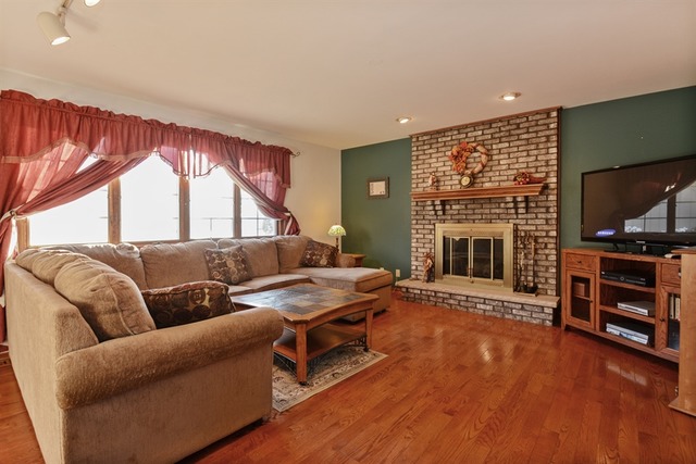11445 Hummingbird Lane Mokena, IL 60448 - Photo 7 of 10 a living room with fireplace furniture and a flat screen tv