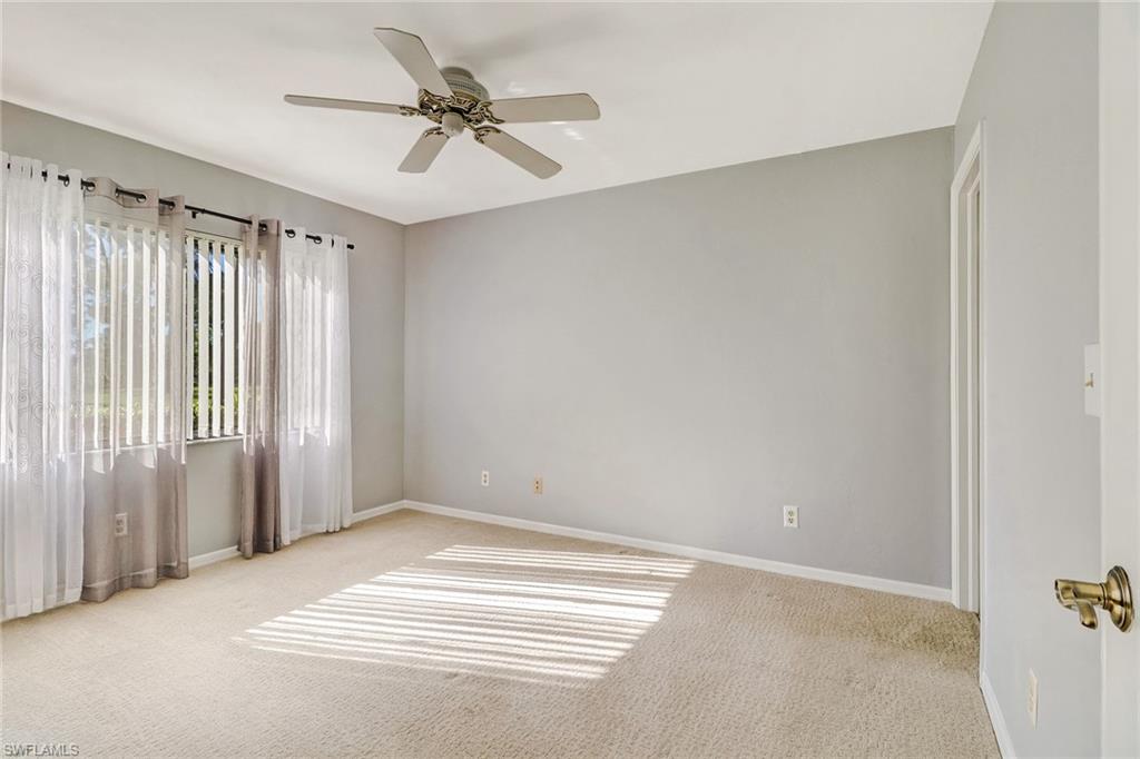 5809 Rattlesnake Hammock Road, Unit 102 Naples, FL 34113 - Photo 11 of 23 a view of a livingroom with a ceiling fan and window