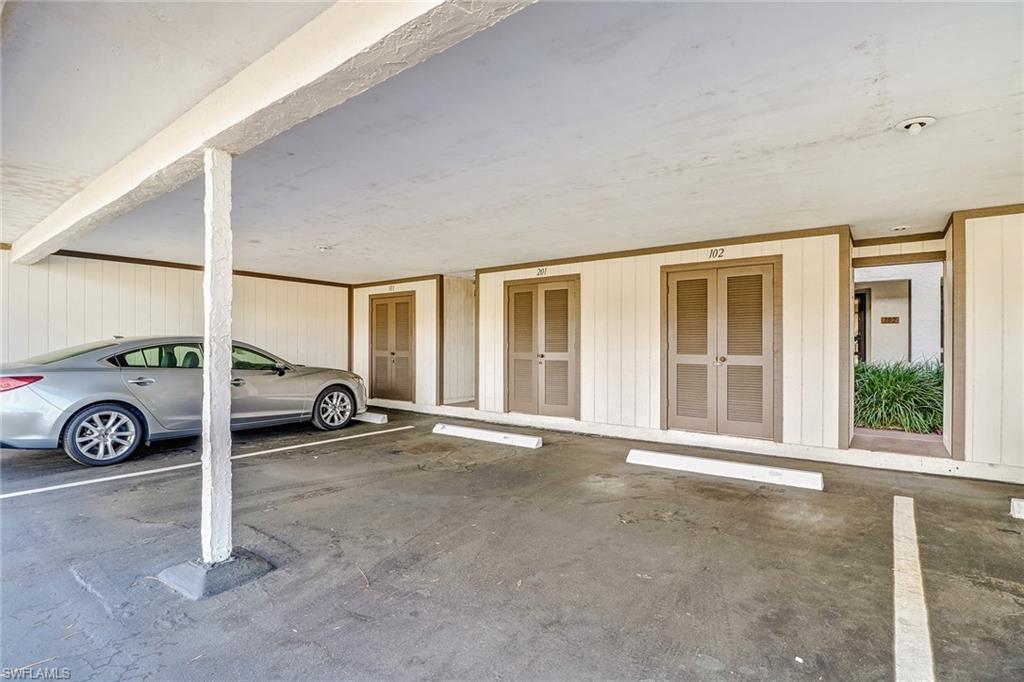 5809 Rattlesnake Hammock Road, Unit 102 Naples, FL 34113 - Photo 20 of 23 a view of a car garage door