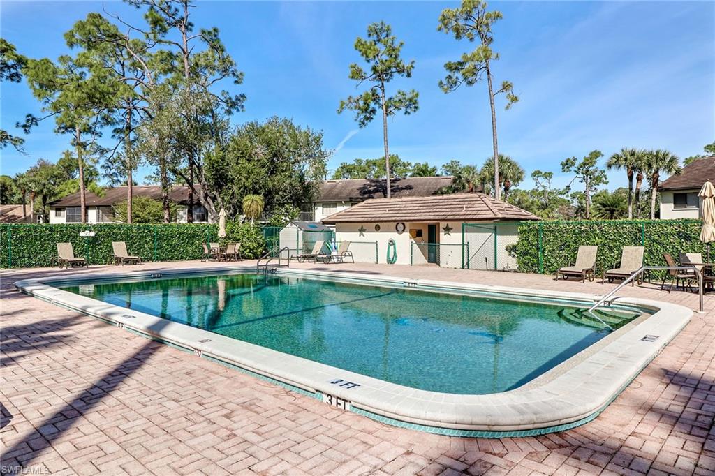 5809 Rattlesnake Hammock Road, Unit 102 Naples, FL 34113 - Photo 23 of 23 a view of a swimming pool with a patio