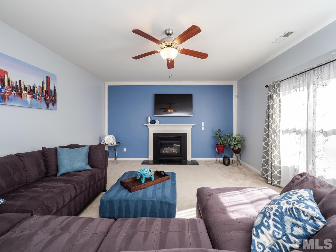 5624 Quitman Trail Raleigh, NC 27610 - Photo 14 of 25 a living room with furniture and a fireplace