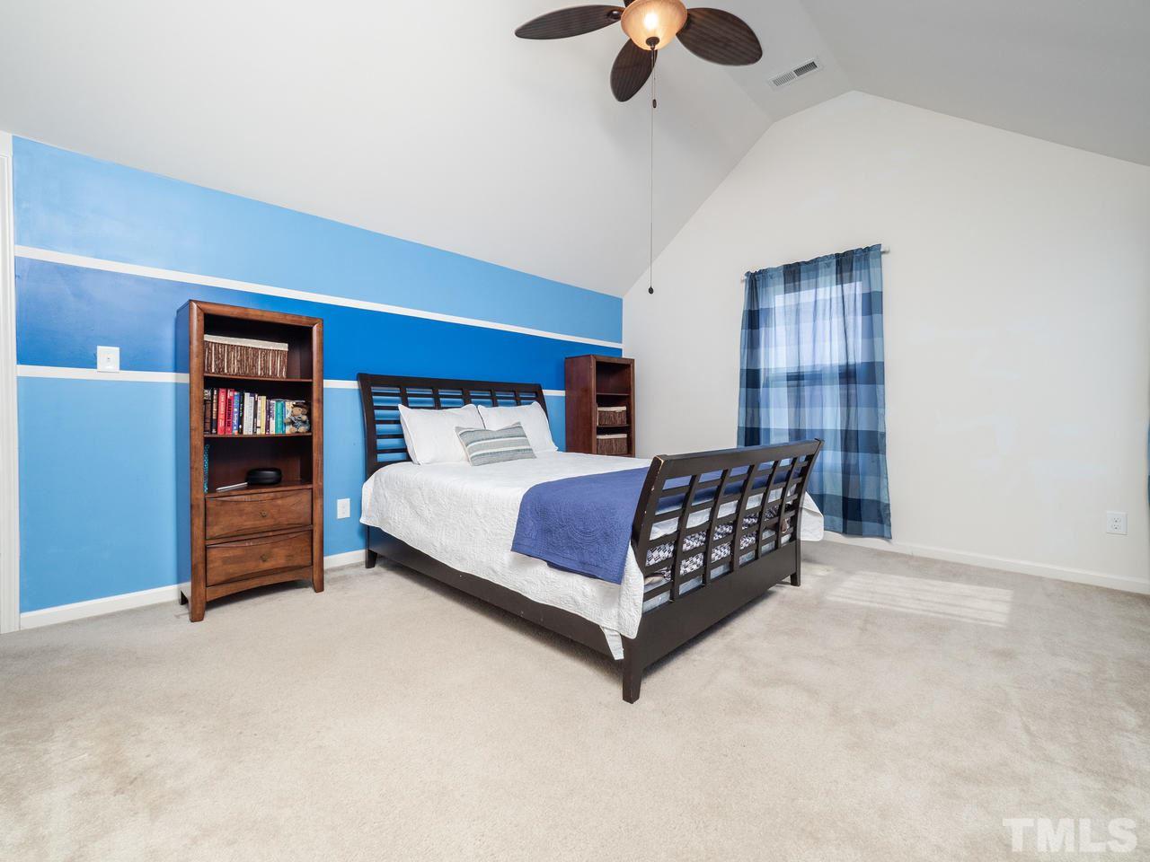 5624 Quitman Trail Raleigh, NC 27610 - Photo 20 of 25 a bedroom with a bed and dresser