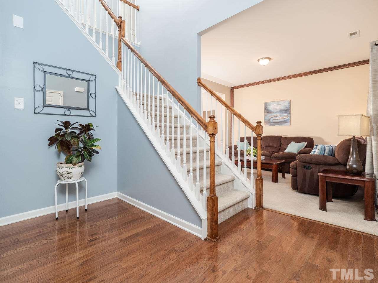 5624 Quitman Trail Raleigh, NC 27610 - Photo 4 of 25 a living room with wooden floor and stairs