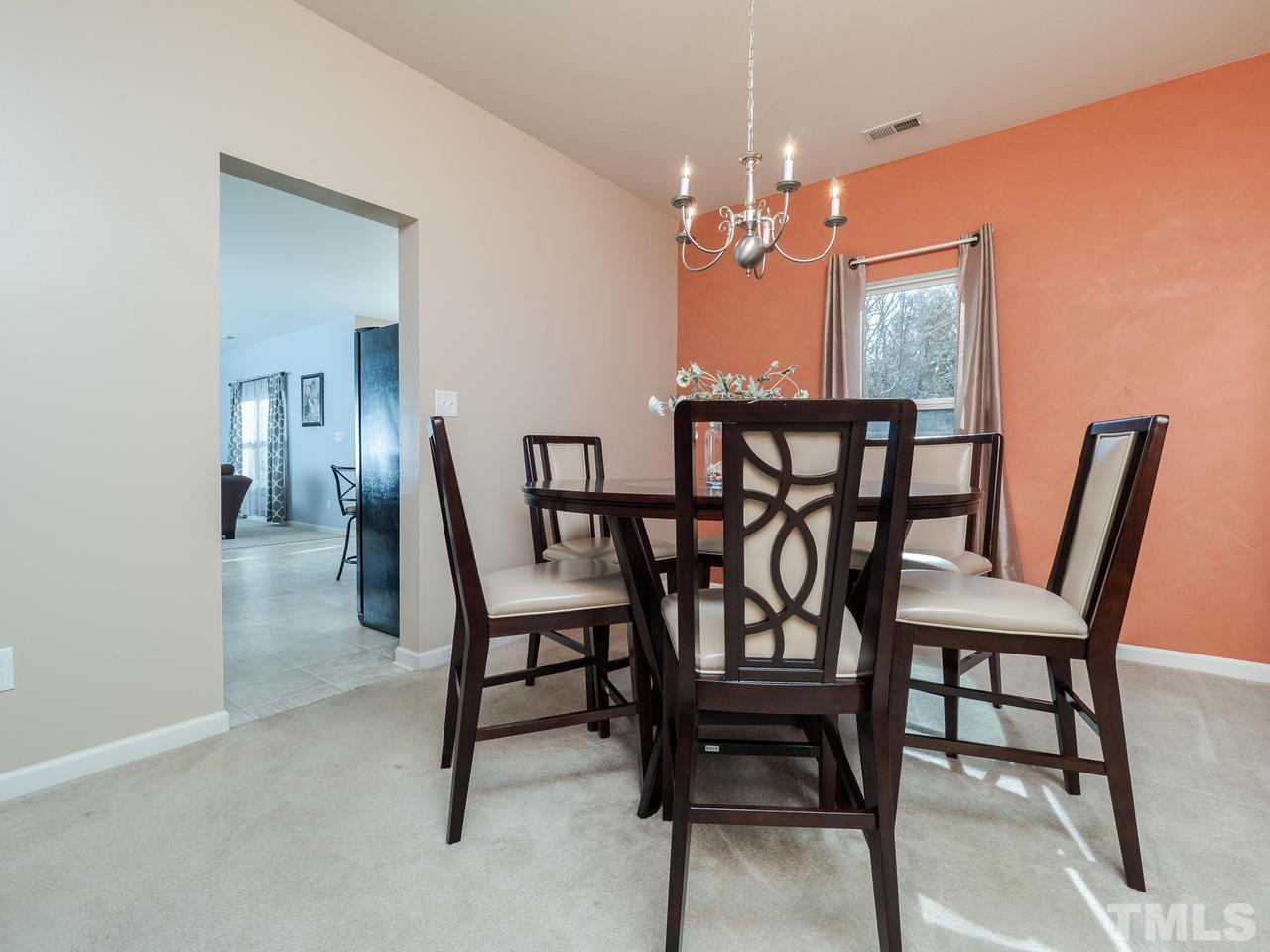 5624 Quitman Trail Raleigh, NC 27610 - Photo 9 of 25 a view of a dining room with furniture and a chandelier