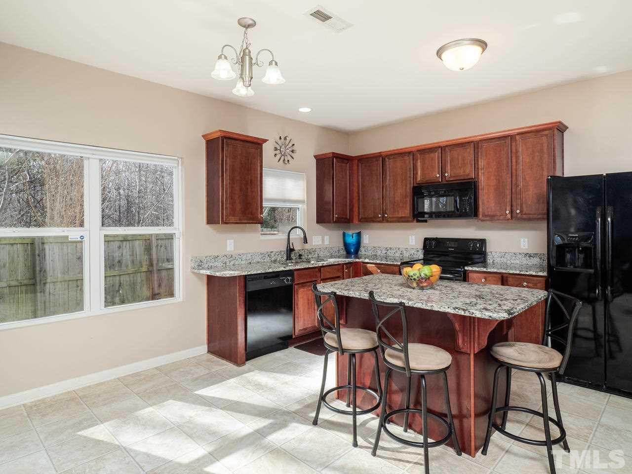 5624 Quitman Trail Raleigh, NC 27610 - Photo 10 of 25 a kitchen with a refrigerator and a stove top oven