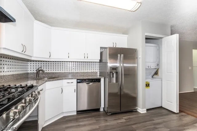 a kitchen with stainless steel appliances a refrigerator and a stove