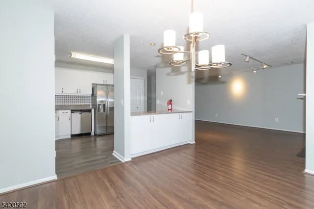 a view of a kitchen with wooden floor