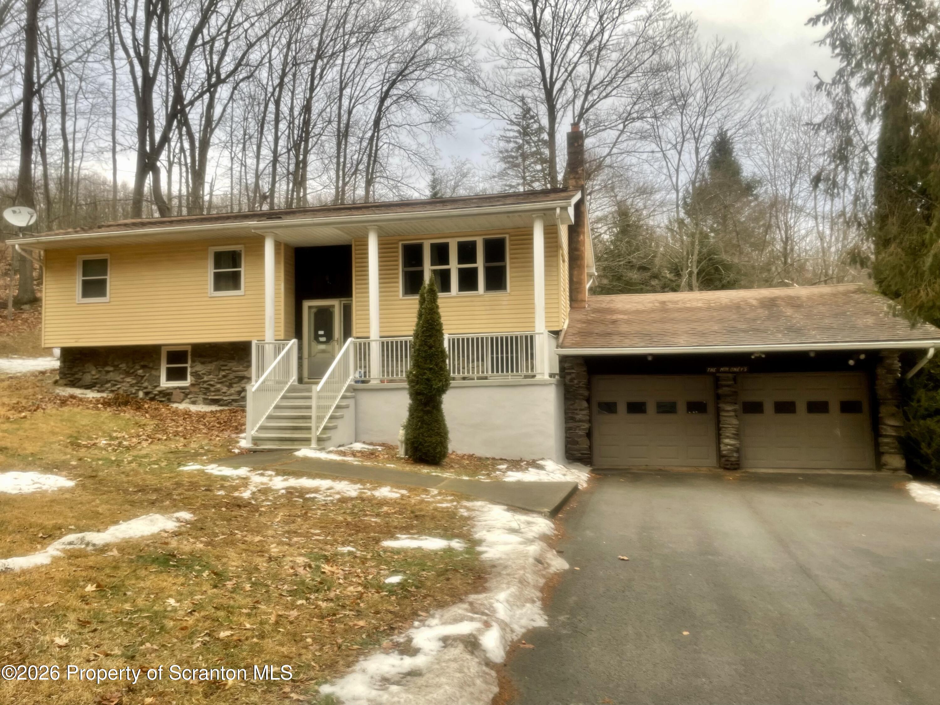 1677 Beaver Pond Road Clarks Summit, PA 18411 - Photo 2 of 21 a view of a house with a yard covered in snow