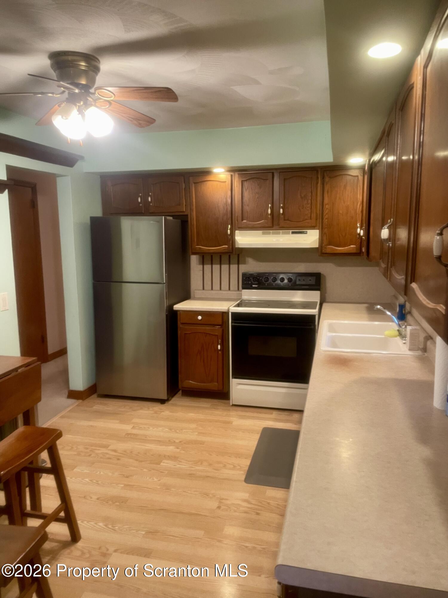 1677 Beaver Pond Road Clarks Summit, PA 18411 - Photo 5 of 21 a kitchen with refrigerator and cabinets