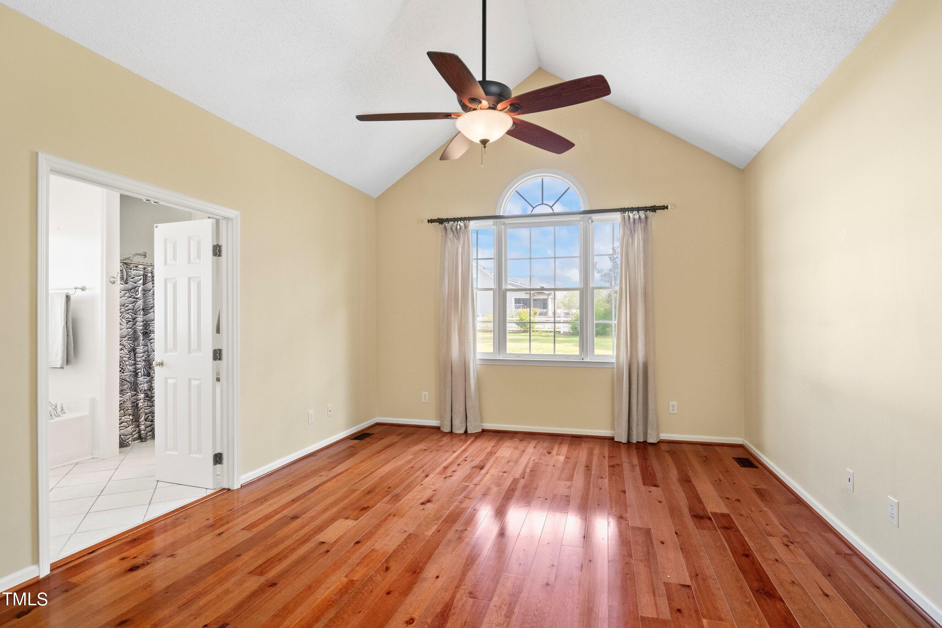 671 Old Evans Road Garner, NC 27529 - Photo 21 of 44 wooden floor in an empty room with a window