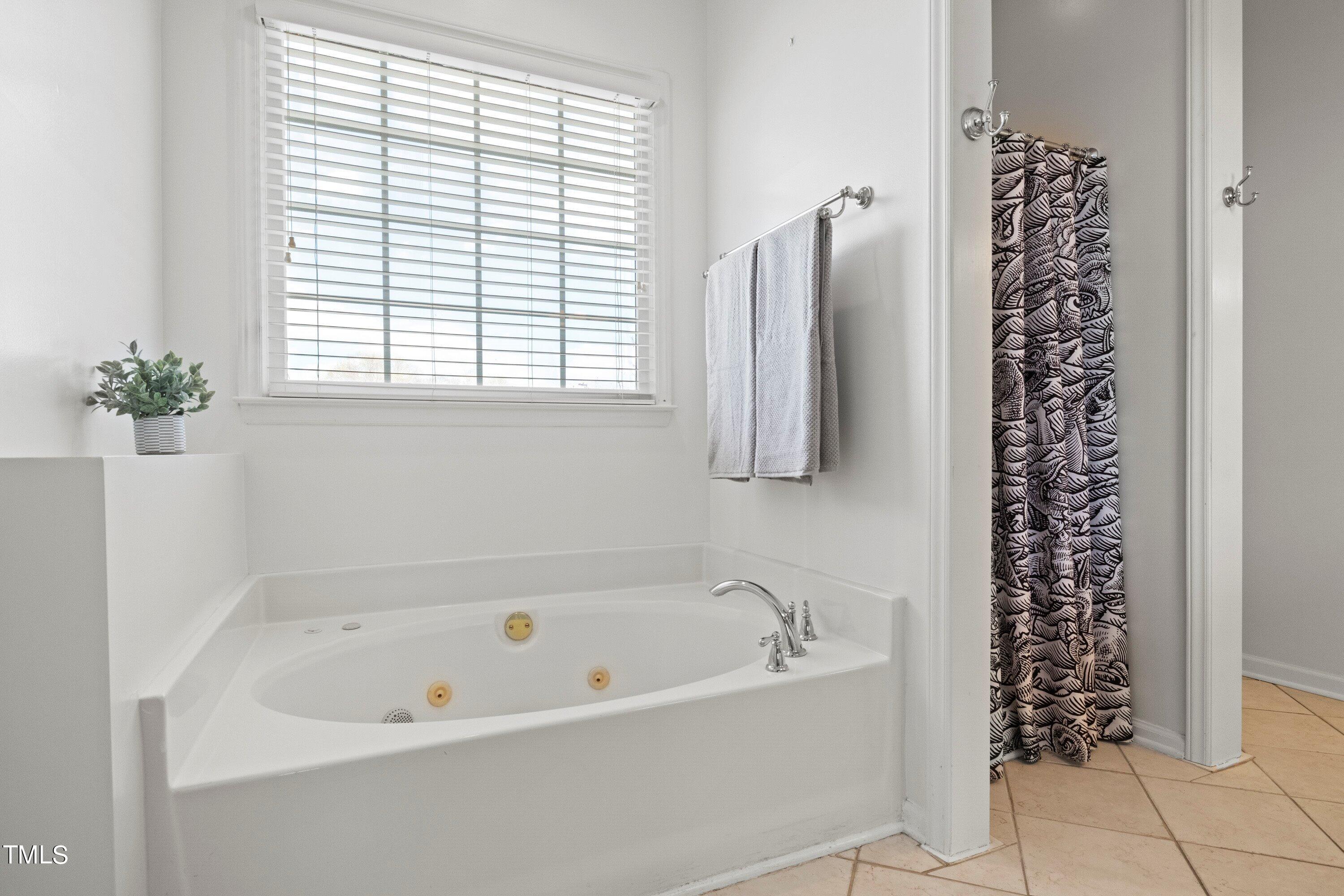 671 Old Evans Road Garner, NC 27529 - Photo 23 of 44 a white bath tub sitting next to a window