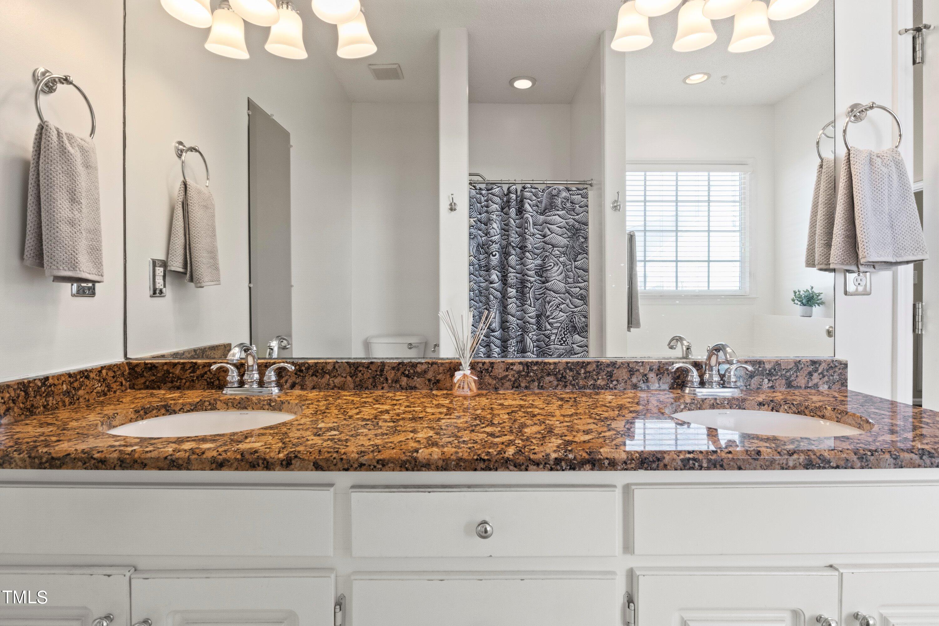 671 Old Evans Road Garner, NC 27529 - Photo 25 of 44 a bathroom with sink granite and mirror