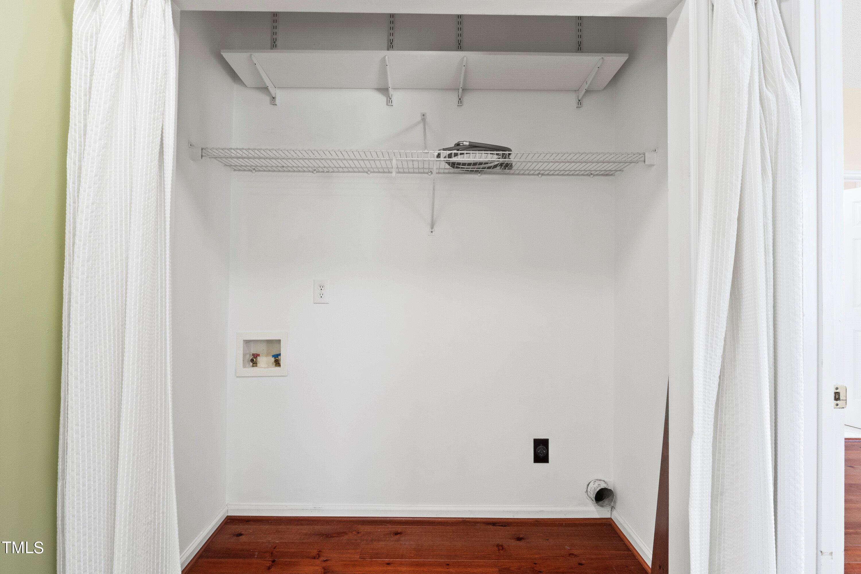 671 Old Evans Road Garner, NC 27529 - Photo 26 of 44 a view of a room with racks on the wall