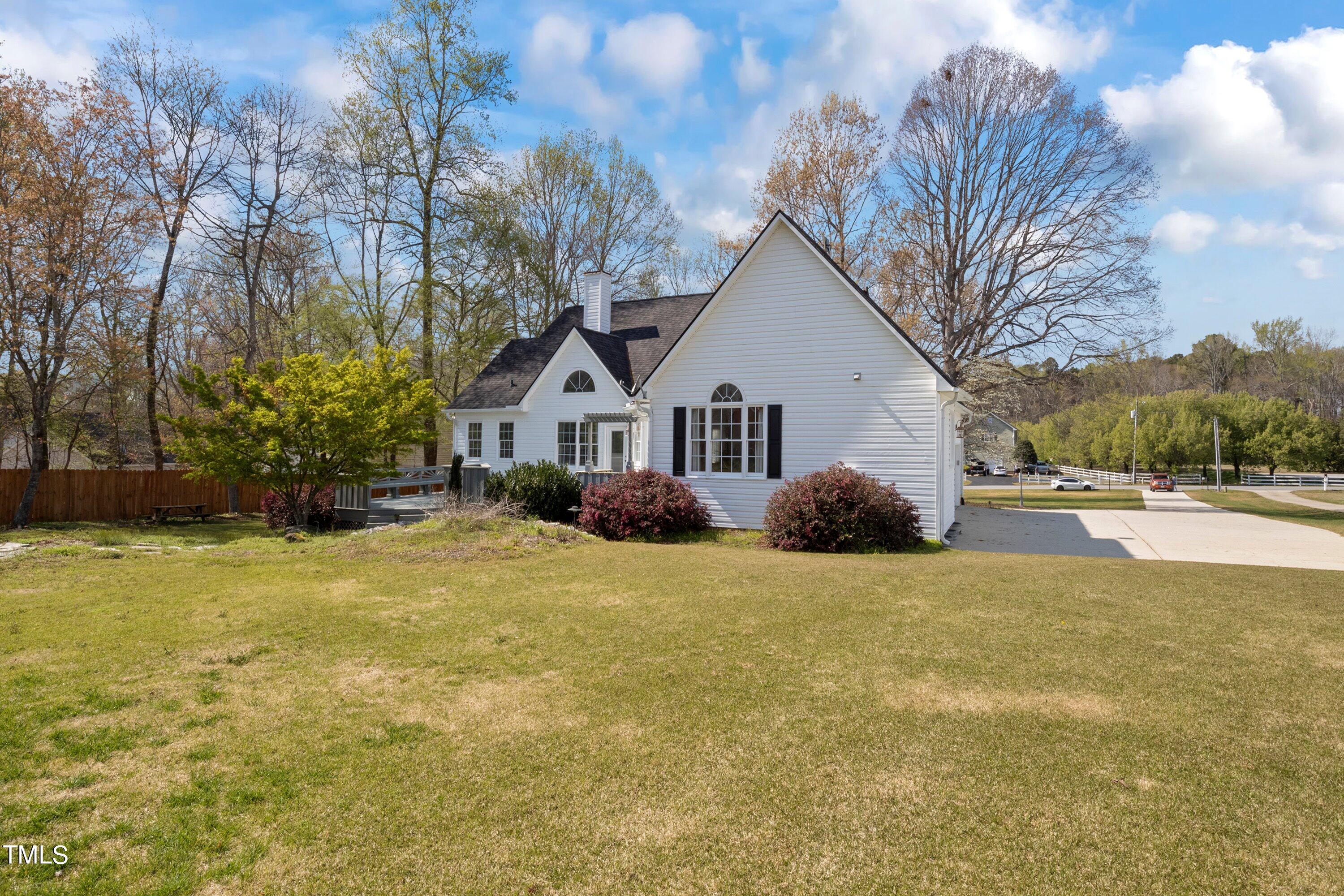 671 Old Evans Road Garner, NC 27529 - Photo 33 of 44 a view of a house with backyard and garden