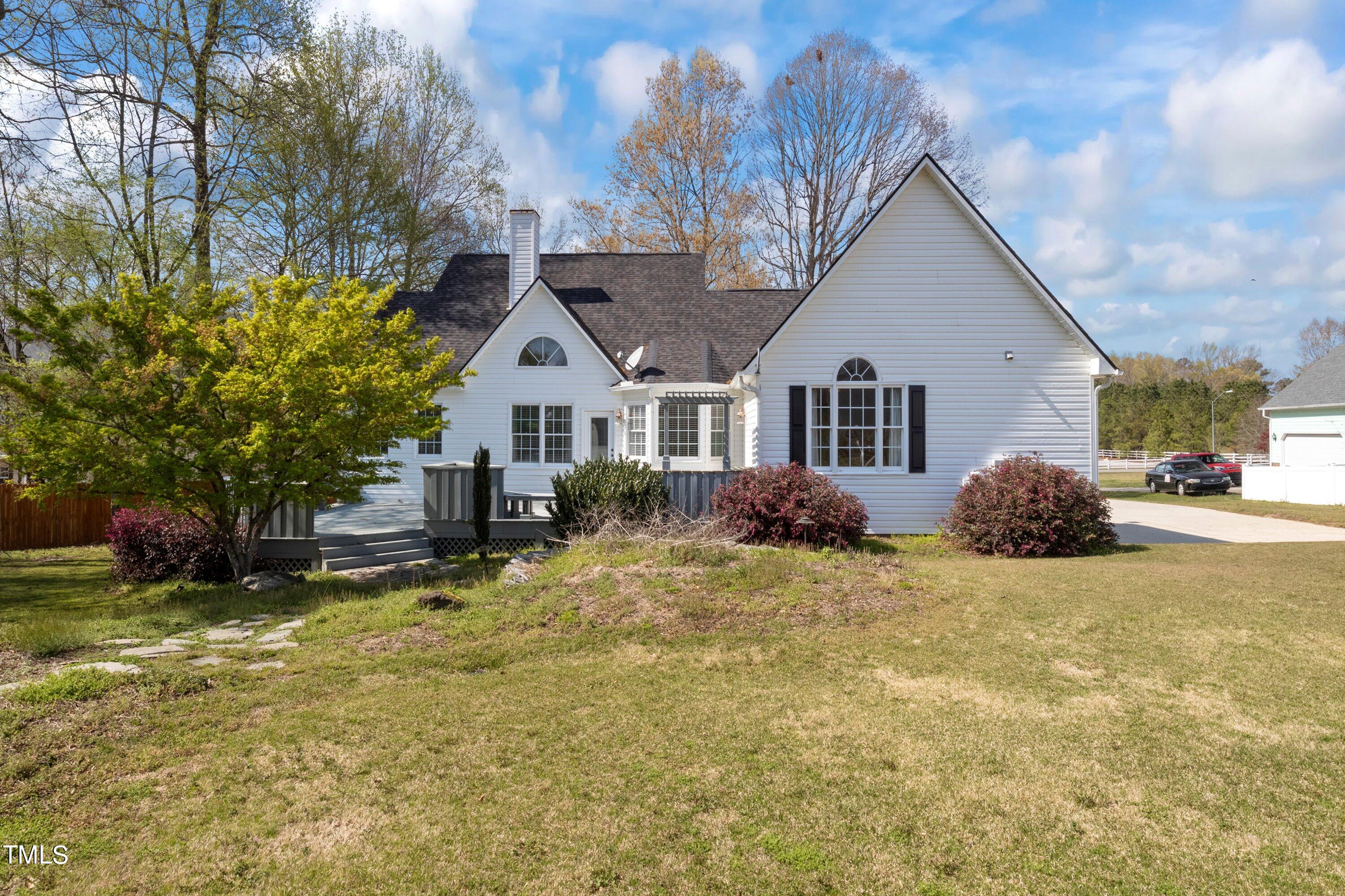 671 Old Evans Road Garner, NC 27529 - Photo 34 of 44 a view of a house with a yard outdoor seating and covered with trees