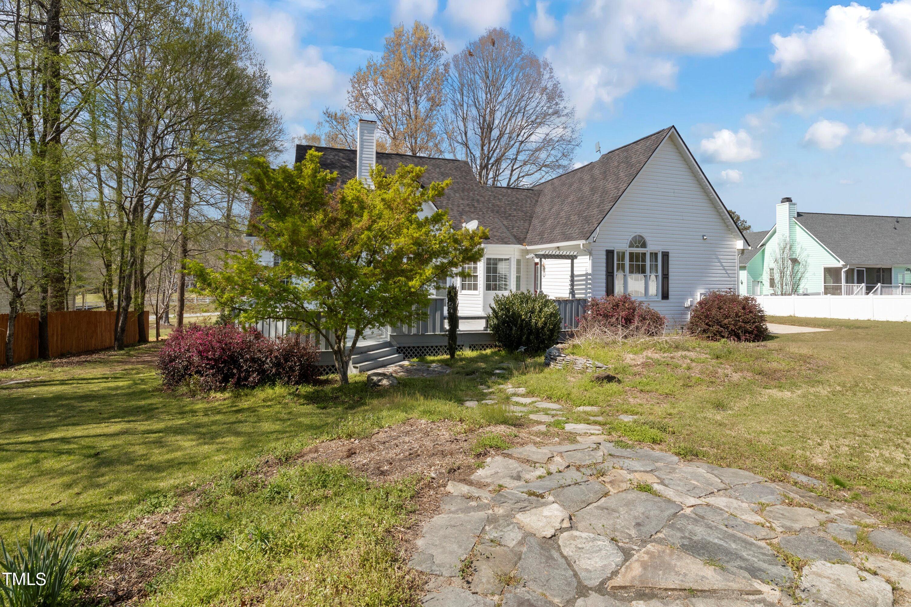 671 Old Evans Road Garner, NC 27529 - Photo 35 of 44 a front view of a house with a garden