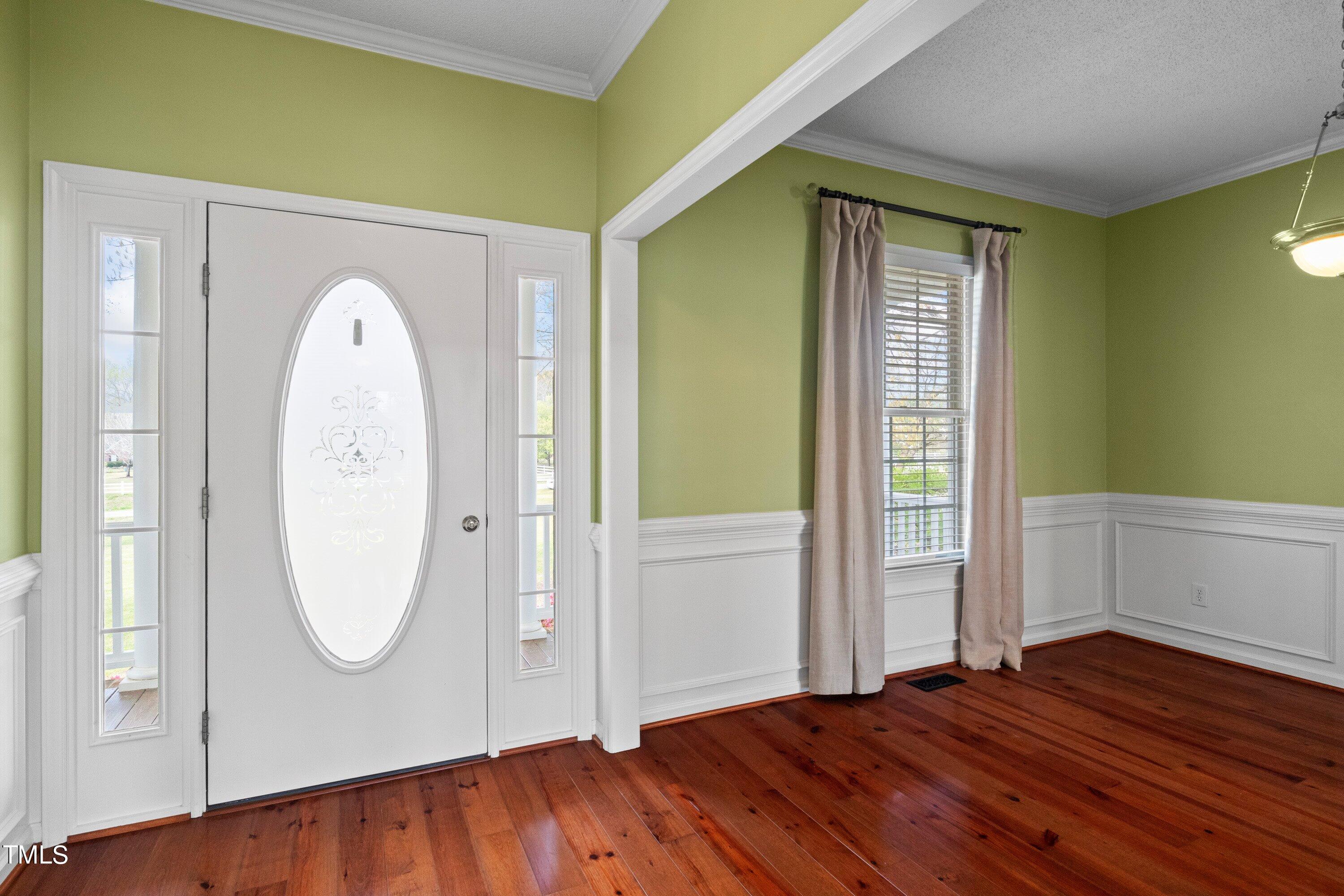 671 Old Evans Road Garner, NC 27529 - Photo 5 of 44 a view of a livingroom with wooden floor and a window