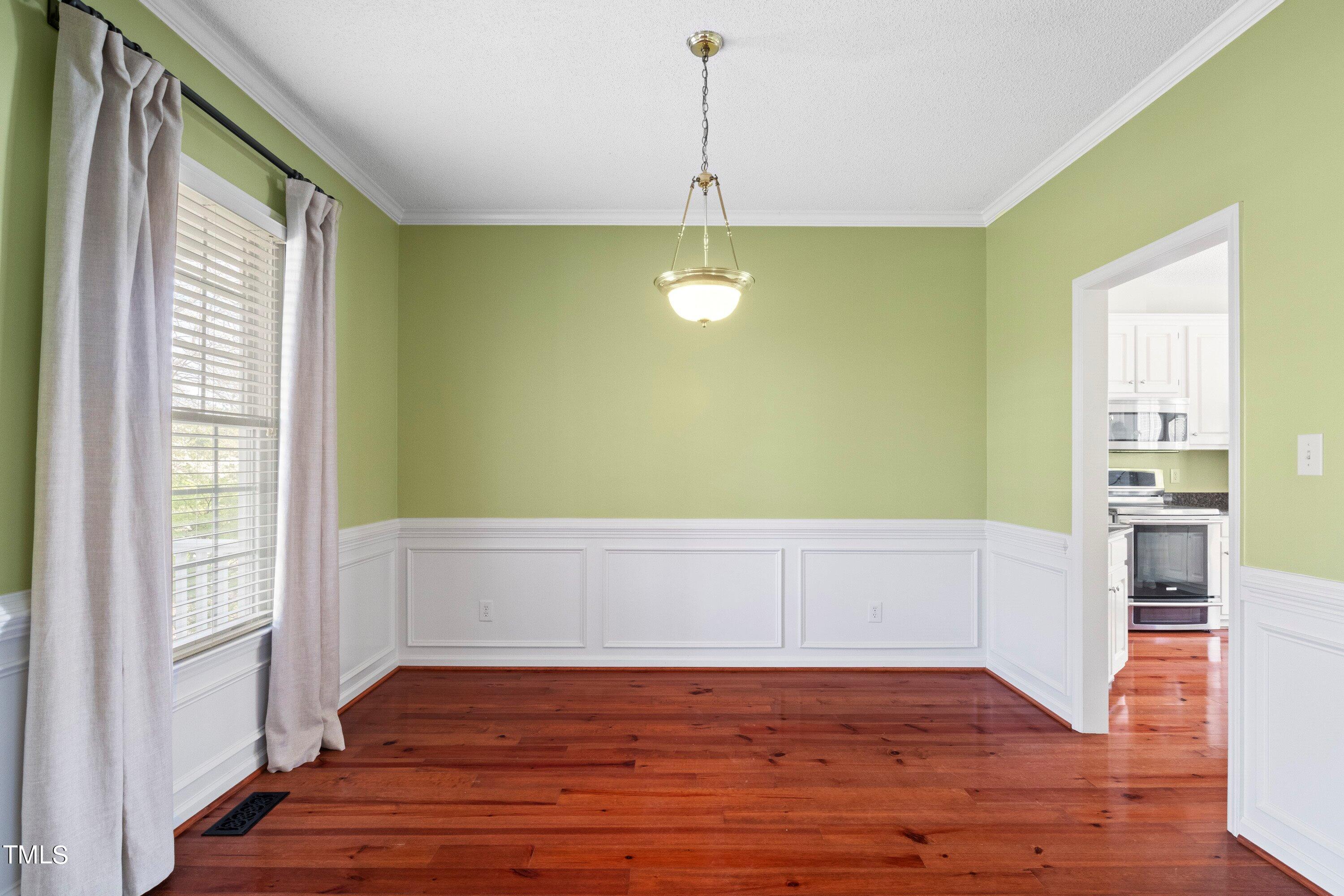 671 Old Evans Road Garner, NC 27529 - Photo 7 of 44 a view of empty room with wooden floor and fan