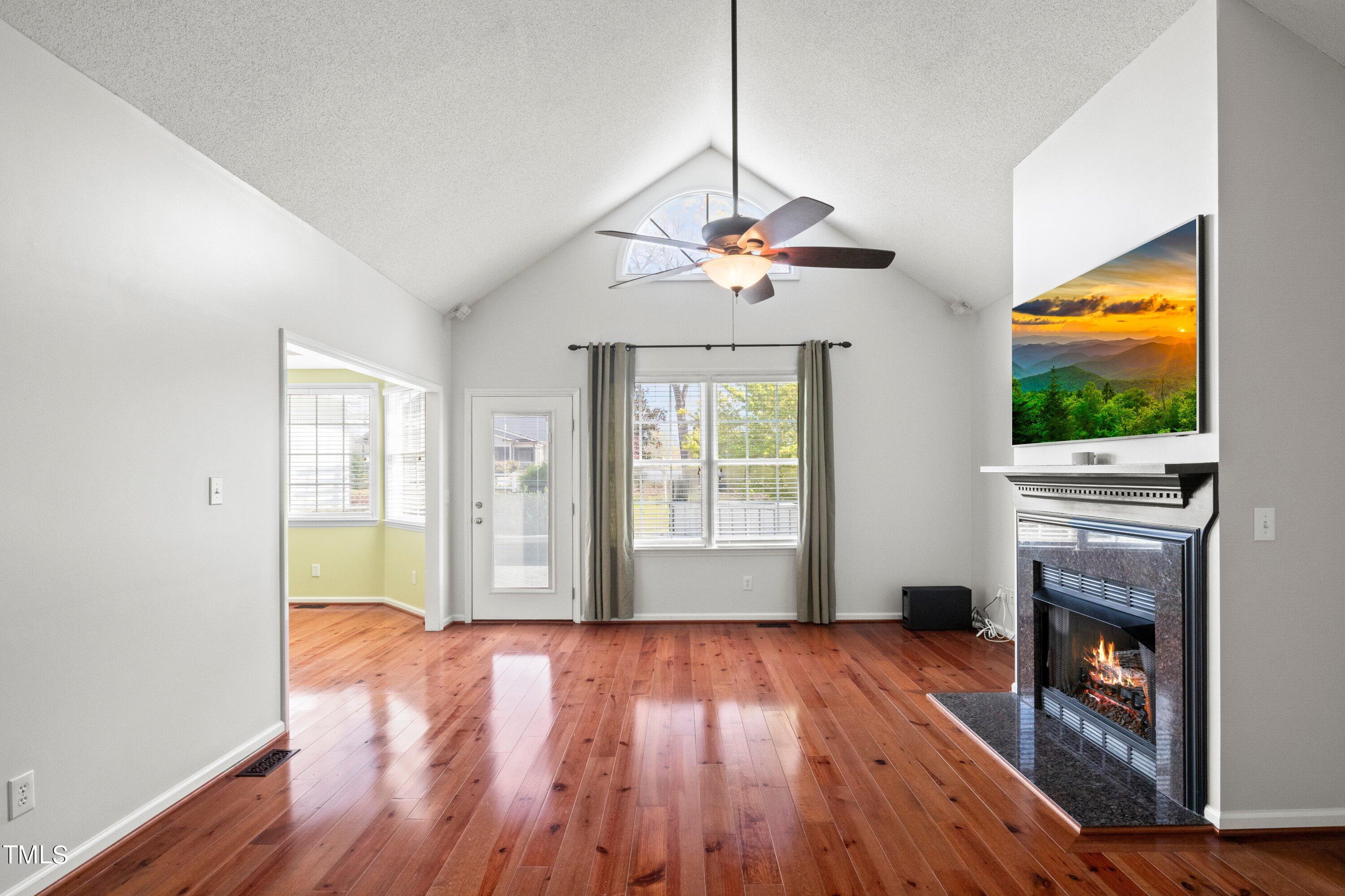 671 Old Evans Road Garner, NC 27529 - Photo 10 of 44 a view of livingroom with fireplace wooden floor and chandelier