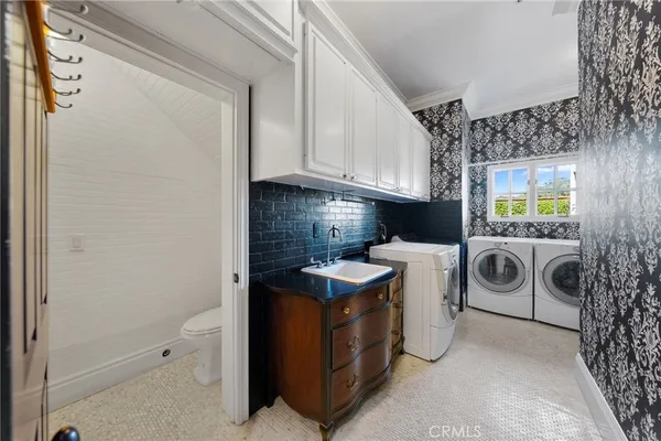 a kitchen with stainless steel appliances kitchen island granite countertop a sink and white cabinets