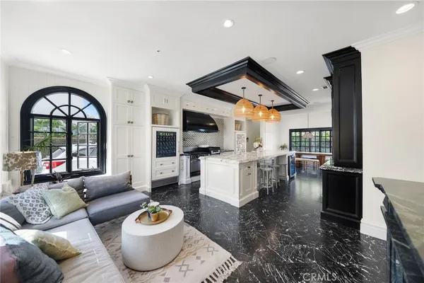 a large white kitchen with a large window