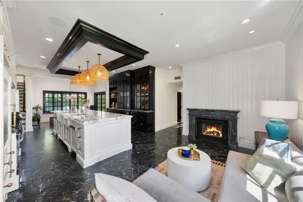 a kitchen with a stove a refrigerator and a fireplace