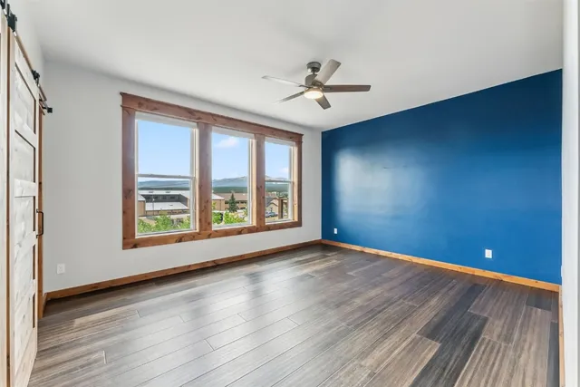 a bathroom with a granite countertop sink a mirror and shower