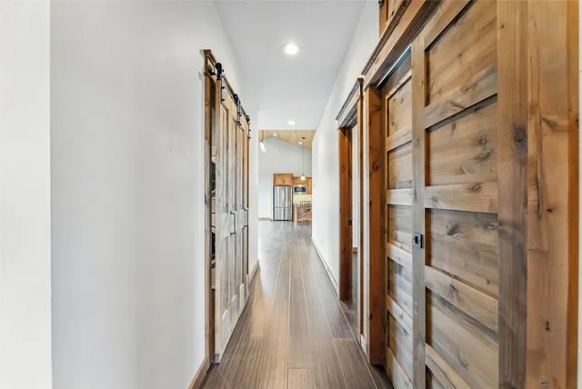 a view of entryway and hall with wooden floor