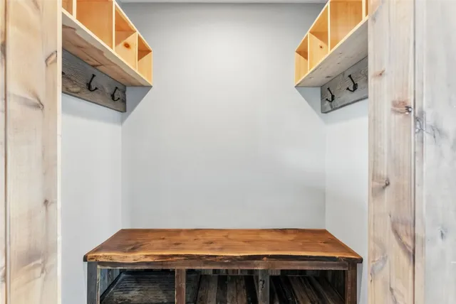 a view of a kitchen with chairs and wooden floor