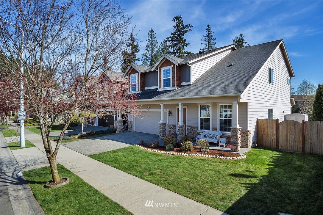 3124 172 Street Southeast Bothell, WA 98012 - Photo 1 of 25 a front view of house with a garden and patio