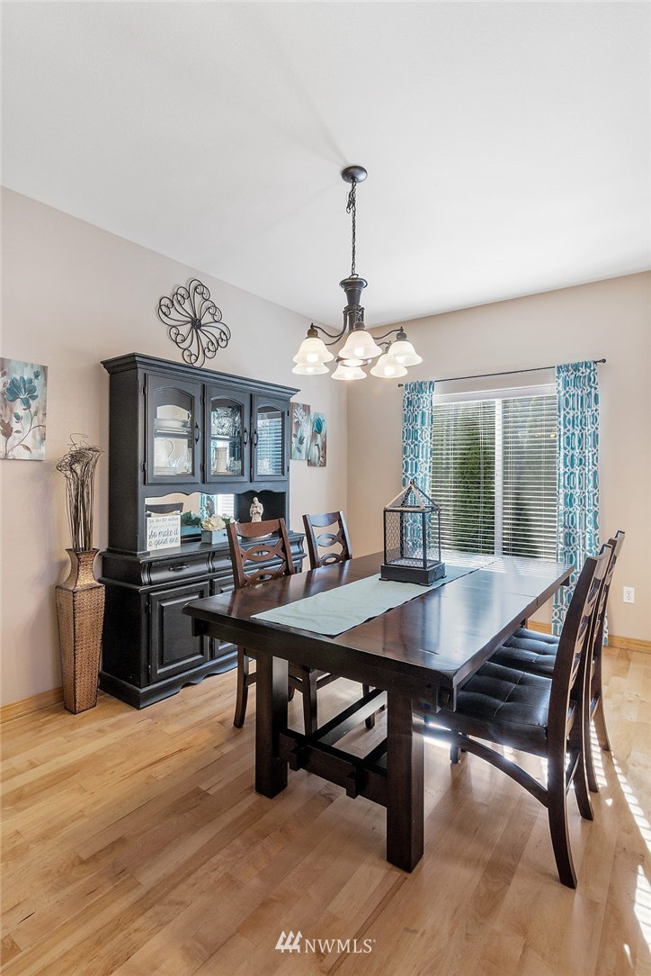 3124 172 Street Southeast Bothell, WA 98012 - Photo 11 of 25 a view of a dining room with furniture window and wooden floor