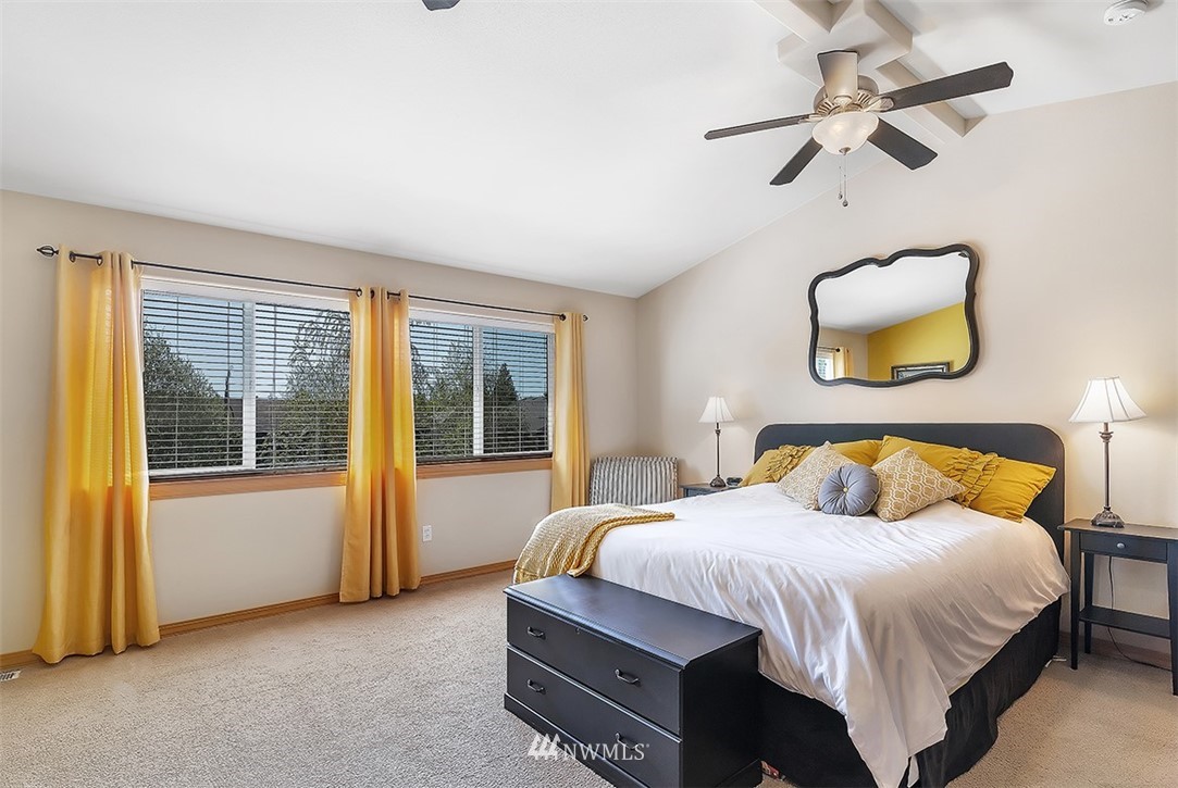 3124 172 Street Southeast Bothell, WA 98012 - Photo 16 of 25 a bedroom with a bed and a chandelier