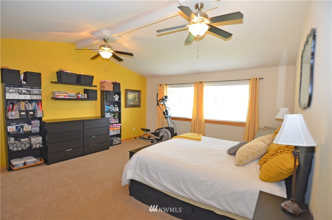 3124 172 Street Southeast Bothell, WA 98012 - Photo 18 of 25 a bedroom with a bed and wooden floor