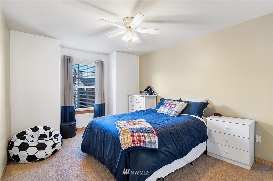 3124 172 Street Southeast Bothell, WA 98012 - Photo 21 of 25 a bedroom with a bed and a chandelier