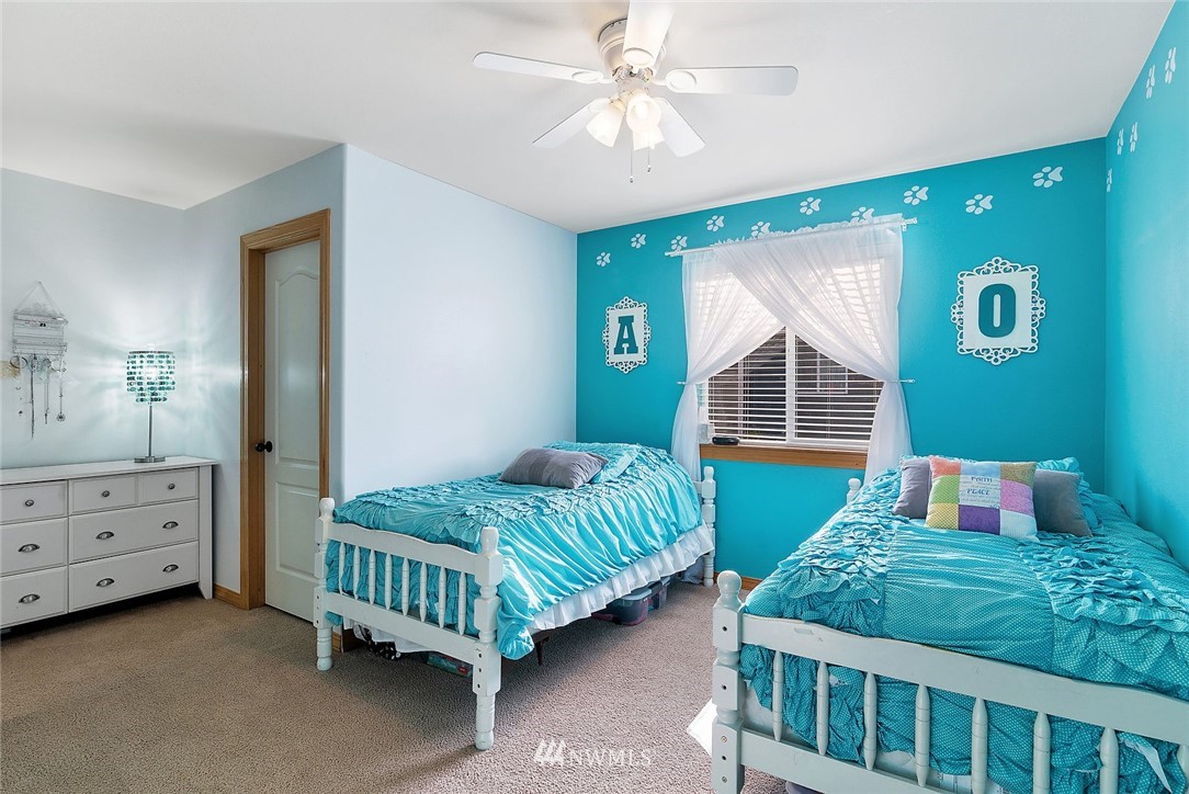 3124 172 Street Southeast Bothell, WA 98012 - Photo 23 of 25 a bedroom with a bed and a dresser