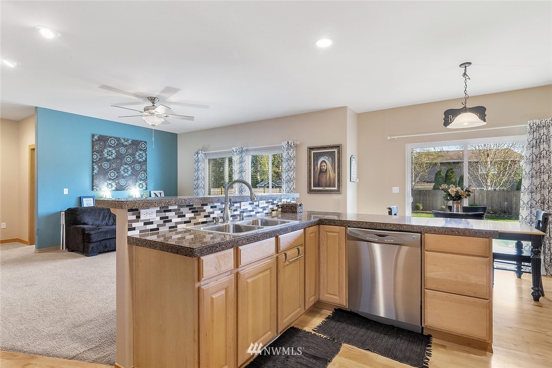 3124 172 Street Southeast Bothell, WA 98012 - Photo 5 of 25 a kitchen with stainless steel appliances granite countertop a stove and a sink