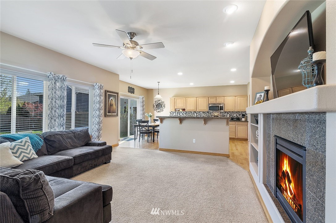 3124 172 Street Southeast Bothell, WA 98012 - Photo 6 of 25 a living room with furniture and a fireplace