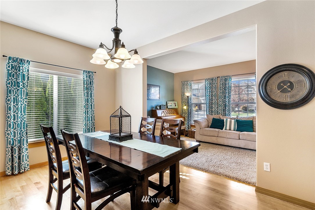 3124 172 Street Southeast Bothell, WA 98012 - Photo 10 of 25 a view of a dining room with furniture window and wooden floor