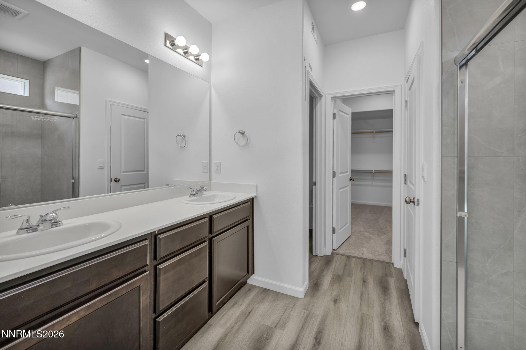 8500 Wicket Drive, Unit LOT 44 Reno, NV 89506 - Photo 20 of 31 a bathroom with a double vanity sink and mirror