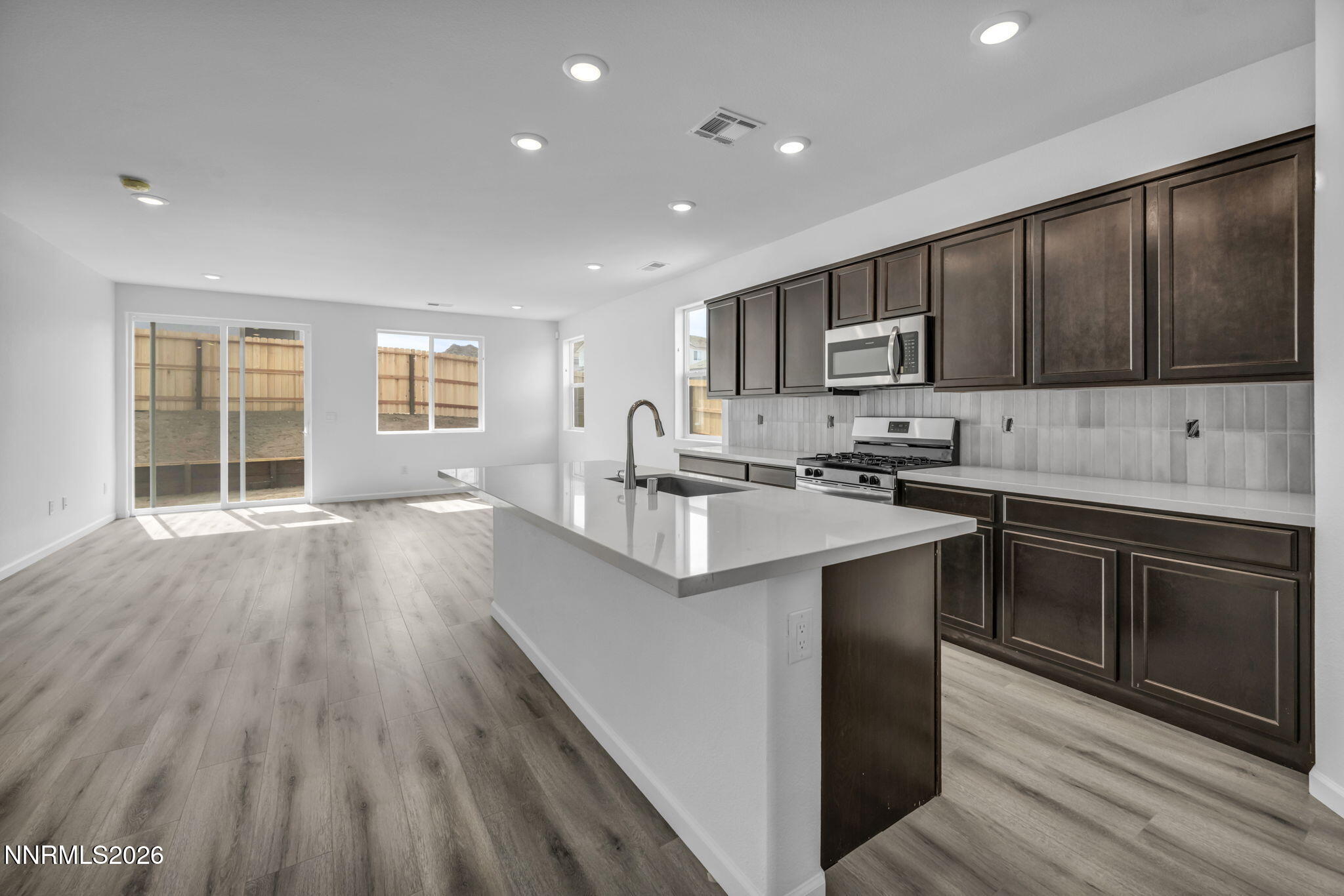 8500 Wicket Drive, Unit LOT 44 Reno, NV 89506 - Photo 2 of 31 a kitchen with stainless steel appliances granite countertop a sink stove and wooden cabinets