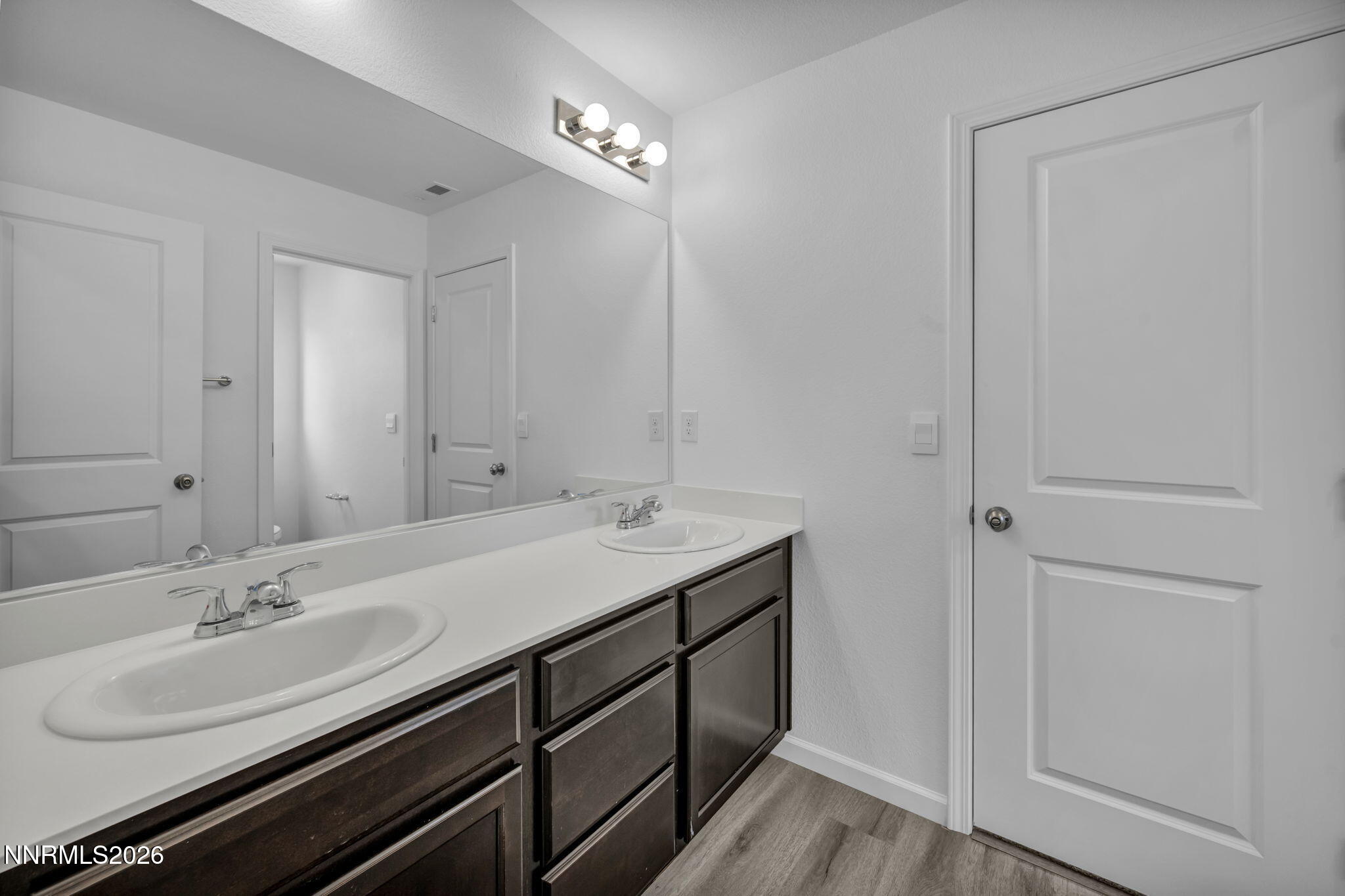 8500 Wicket Drive, Unit LOT 44 Reno, NV 89506 - Photo 21 of 31 a bathroom with a double vanity sink and a mirror