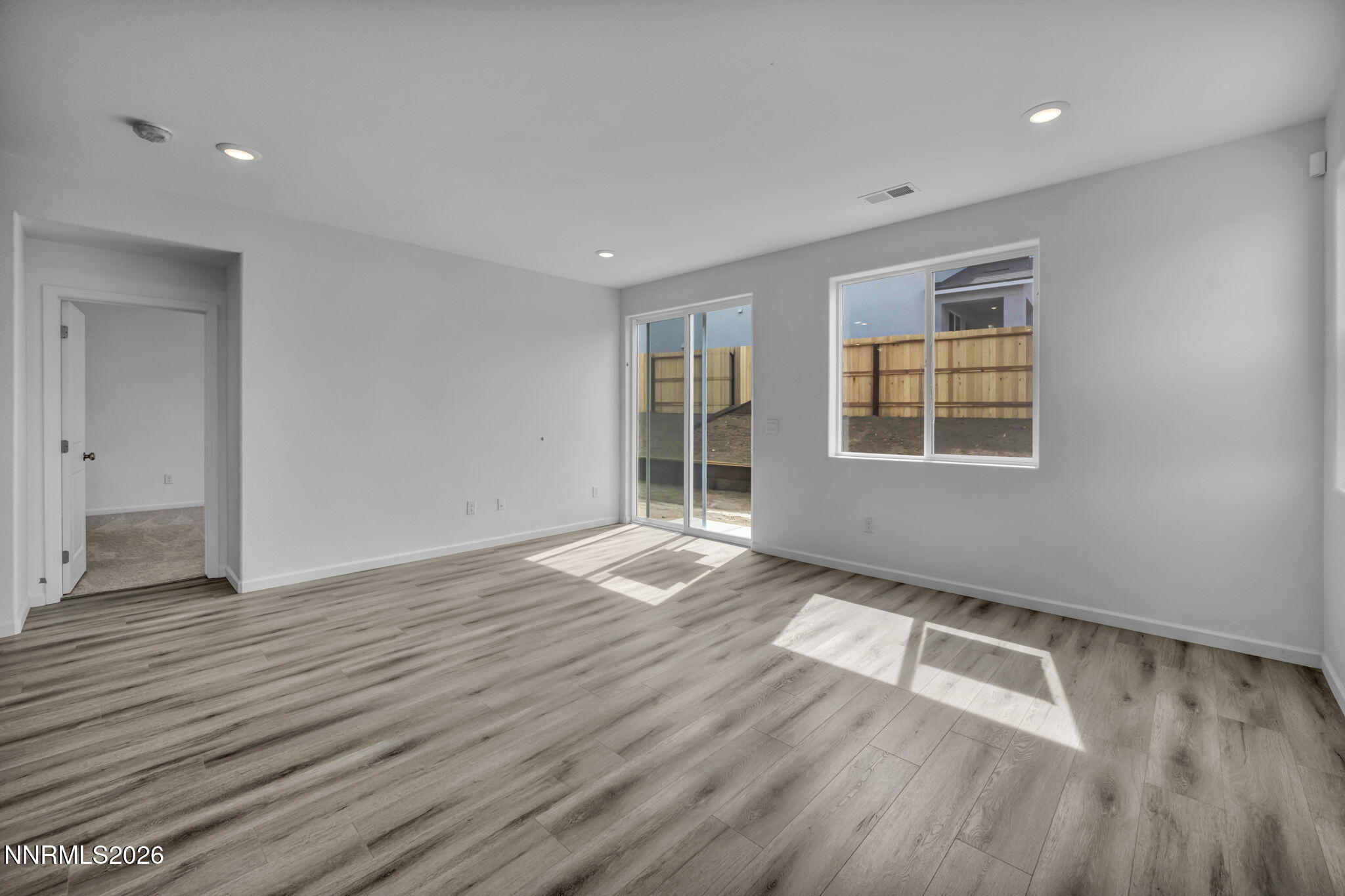 8500 Wicket Drive, Unit LOT 44 Reno, NV 89506 - Photo 4 of 31 an empty room with wooden floor and windows