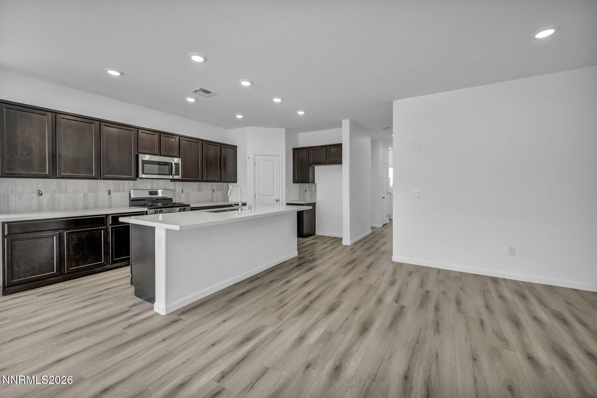 8500 Wicket Drive, Unit LOT 44 Reno, NV 89506 - Photo 7 of 31 a kitchen with stainless steel appliances a stove top oven a refrigerator and cabinets