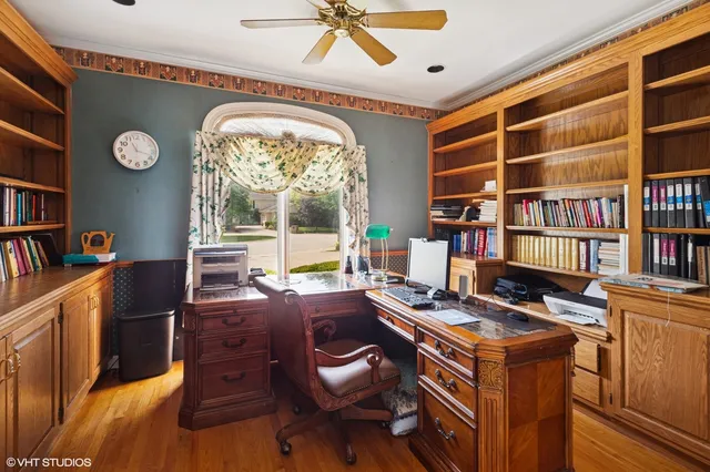 a view of a workspace with furniture and a bookshelf
