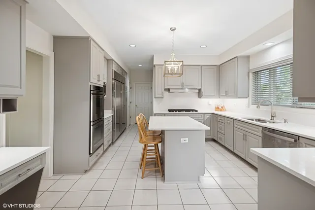 a kitchen with a sink appliances and cabinets